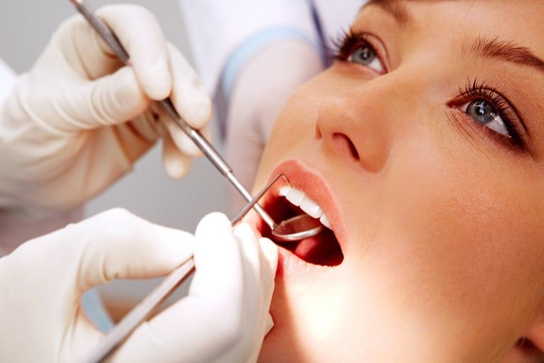 Woman getting her teeth checked