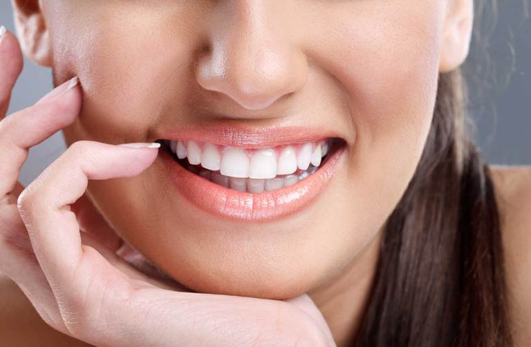 Close up of womans straight white teeth