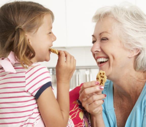 Grandmother and her granddaughter baking cookies