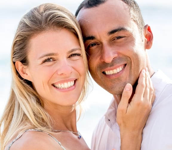 Couple holding each other at the beach