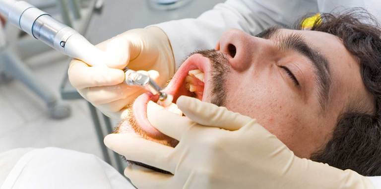 Man getting his teeth polished